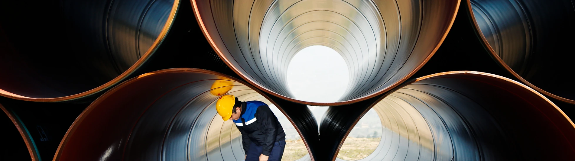 Worker inside industrial pipes