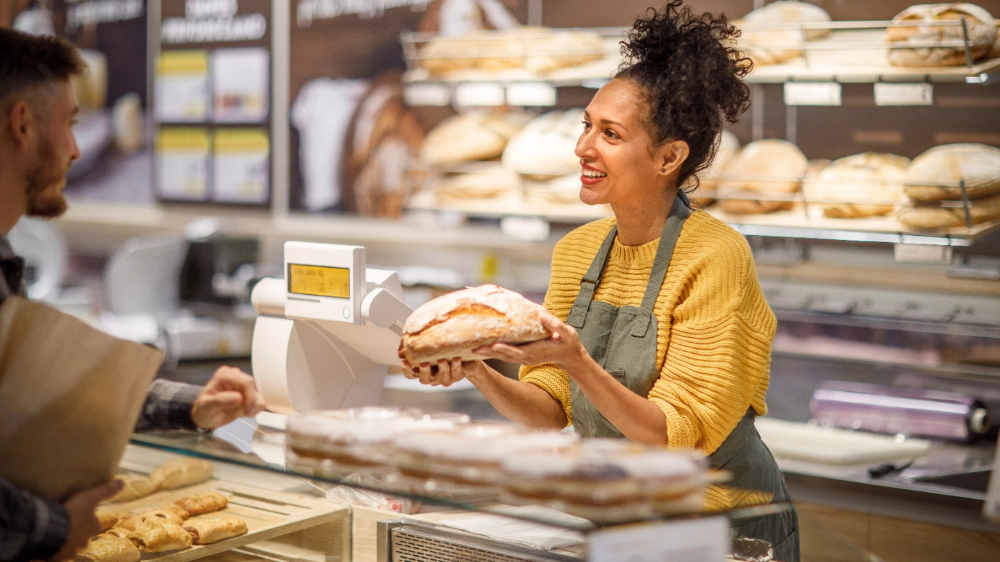 Woman selling bread at a bakery image