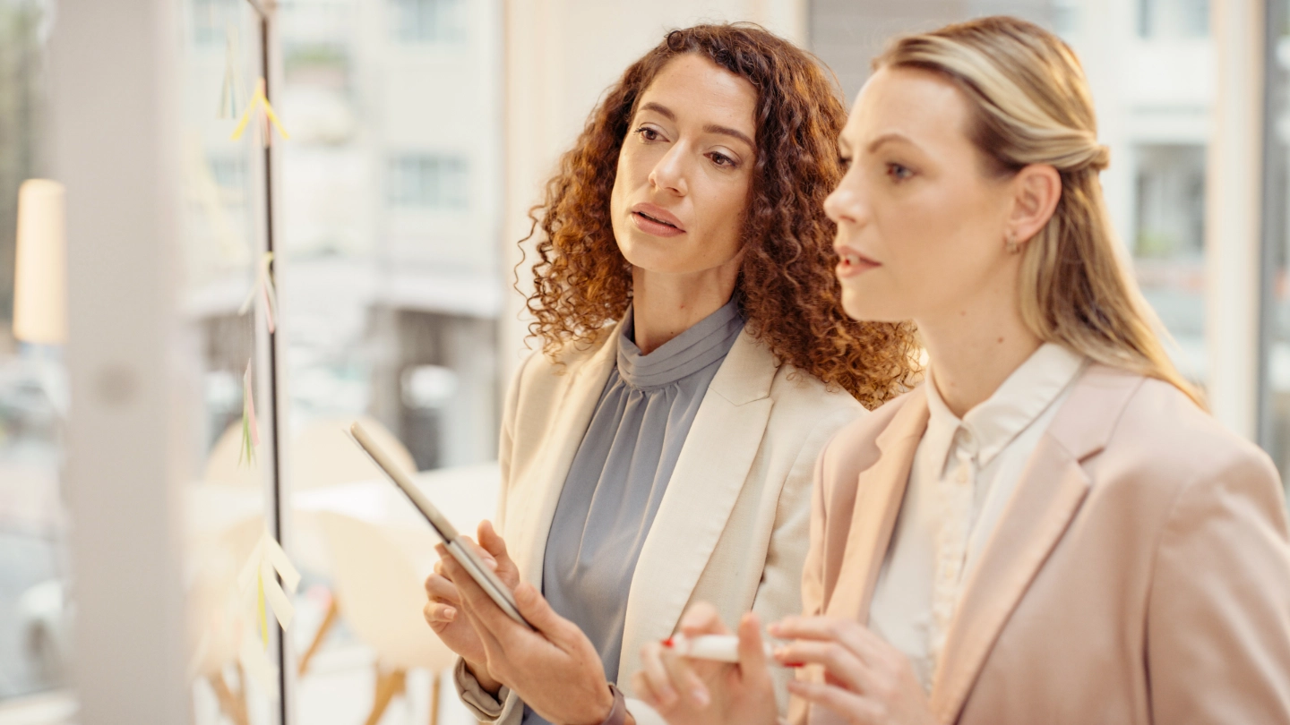 two women at a board image