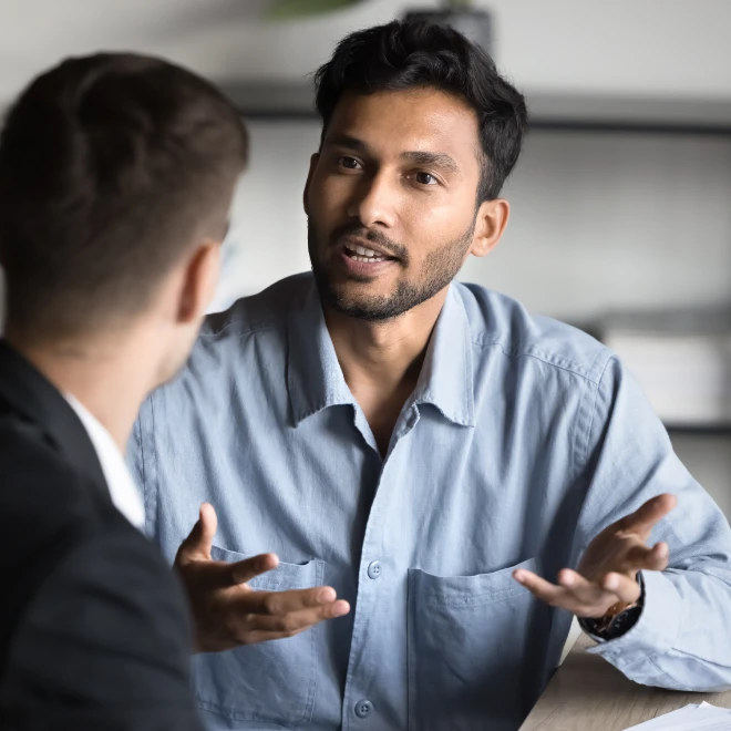 man talking with another man using hands